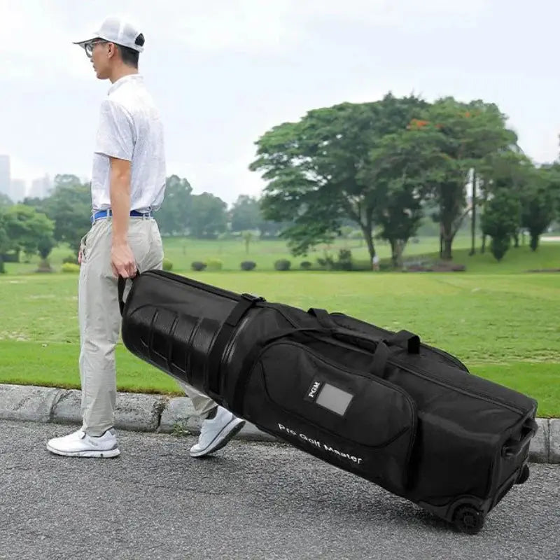 Golfer pulling a PGM hard shell golf aviation bag with wheels, demonstrating its ease of transport on the golf course.